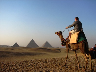 Featured is a photo of a gentleman on an escorted camel tour of the Giza Pyramids.  Sign me up.  Photo by Amanda Rynes of Seattle, Washington.
